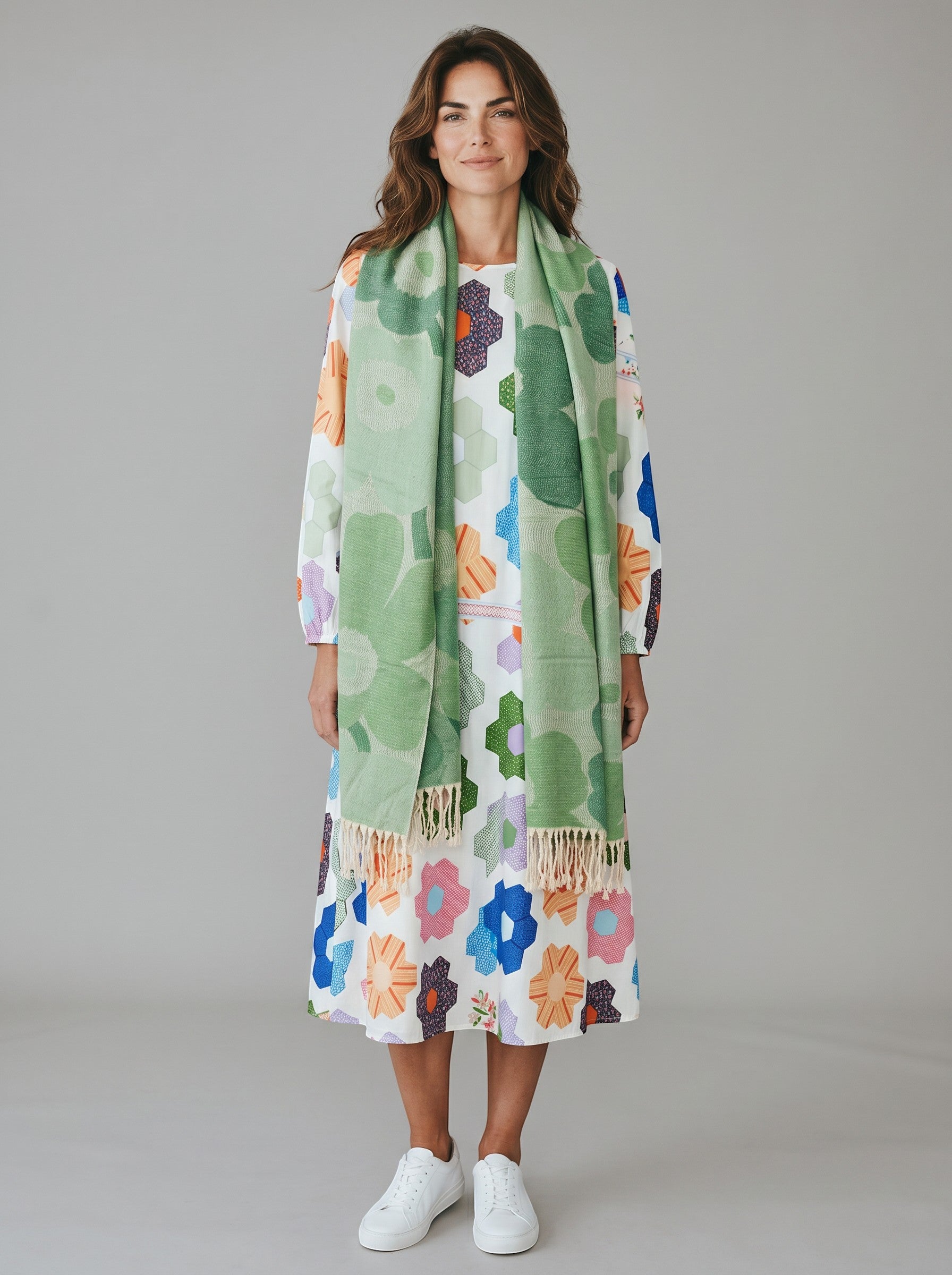 Model wearing a Color's Wholesale viscose floral print midi dress and a green patterned scarf with fringe trim.