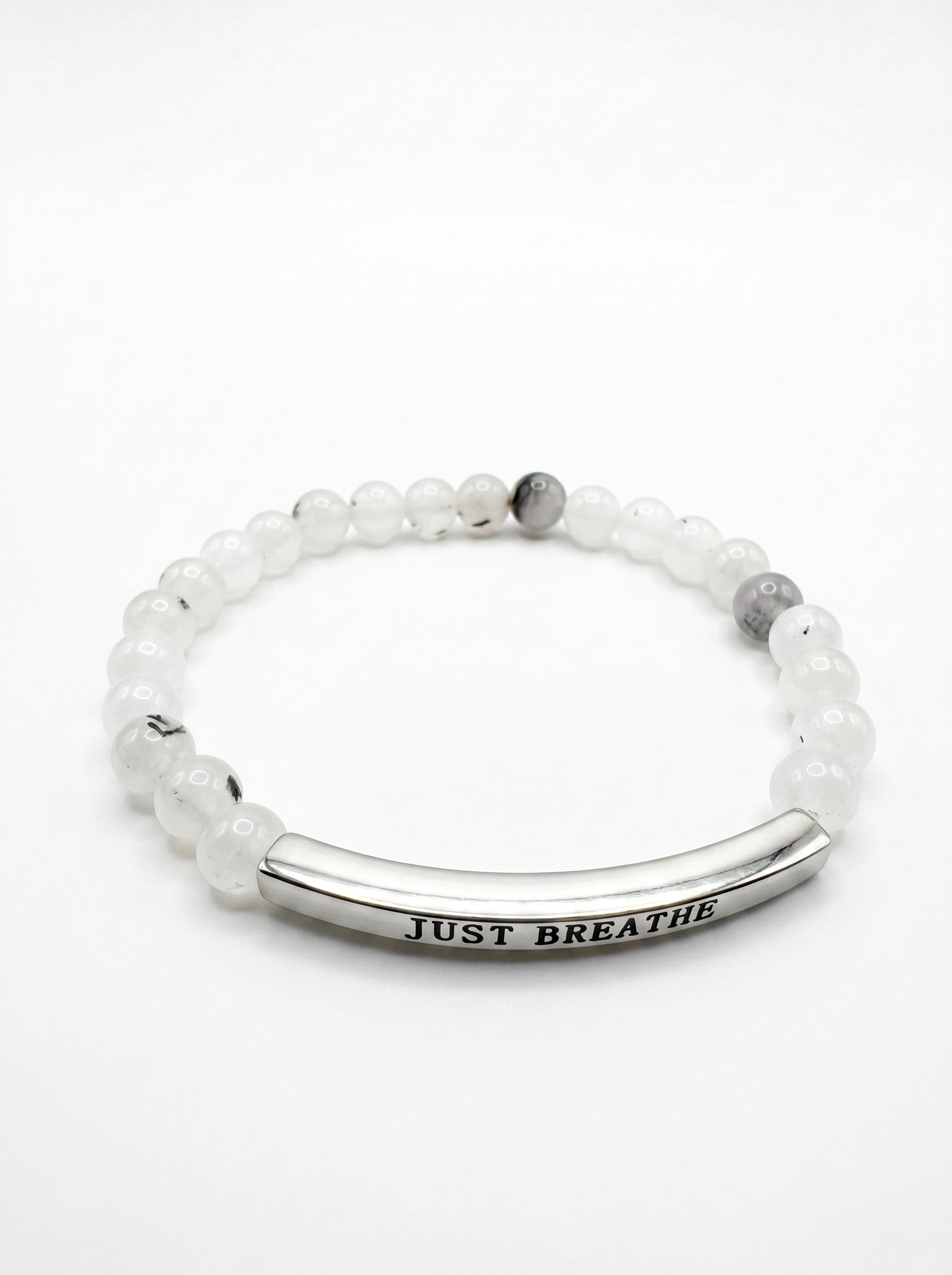 Color's Wholesale beaded bracelet with white stone beads and a silver curved bar engraved with Just Breathe