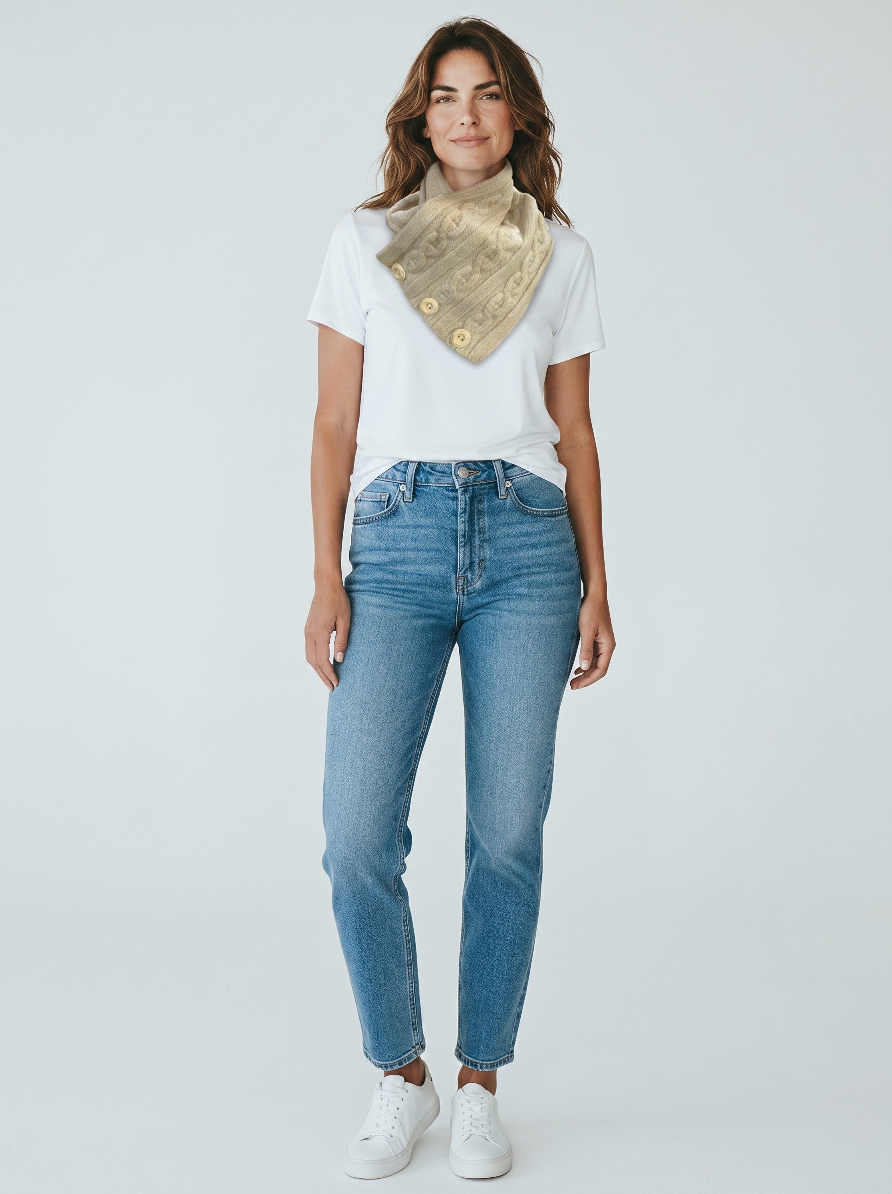Color's Wholesale beige cable knit neck warmer with button details worn by a woman in a white t-shirt and jeans