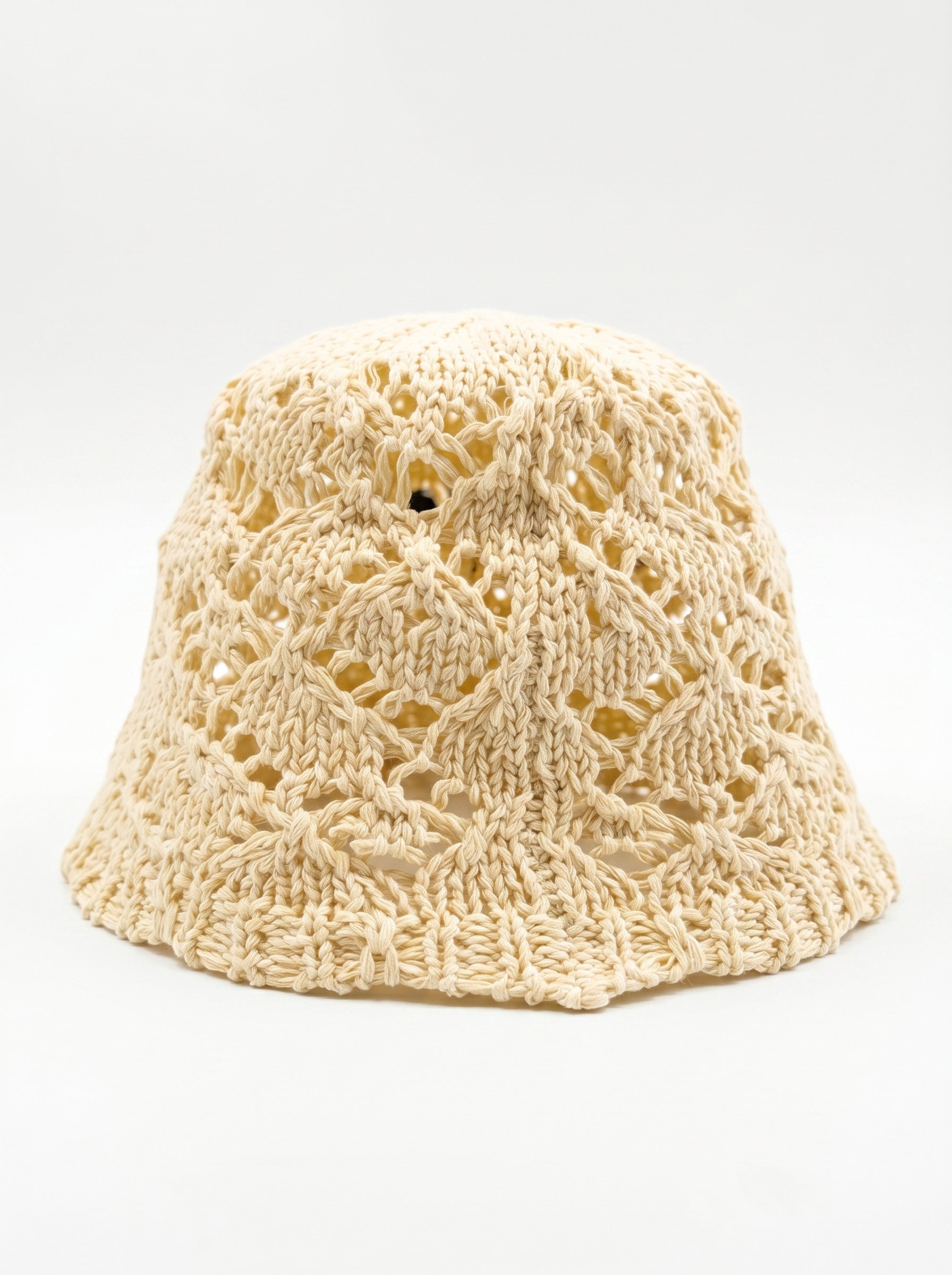 Color's Wholesale beige crocheted cotton bucket hat with openwork diamond pattern and delicate flower appliqué detail.
