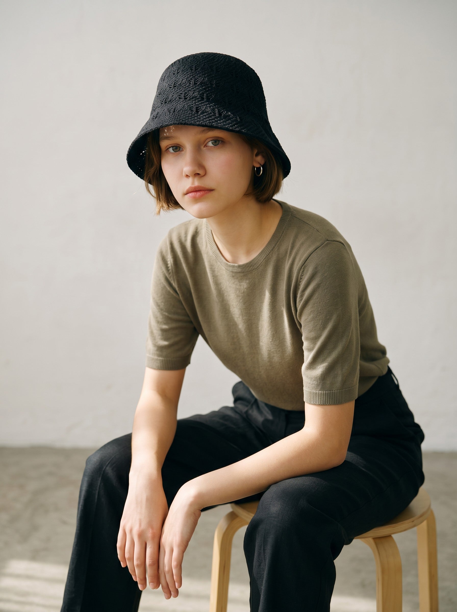 Color's Wholesale black crocheted cotton bucket hat with intricate openwork detail.