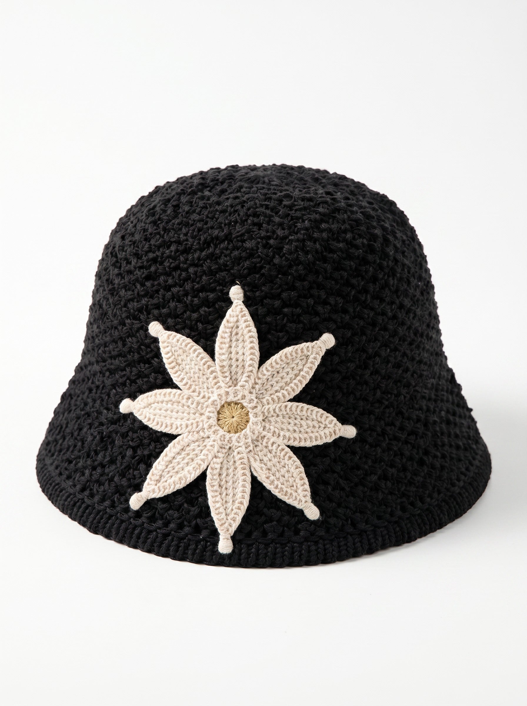 Color's Wholesale black crocheted cotton bucket hat with a beige flower appliqué and tan center.