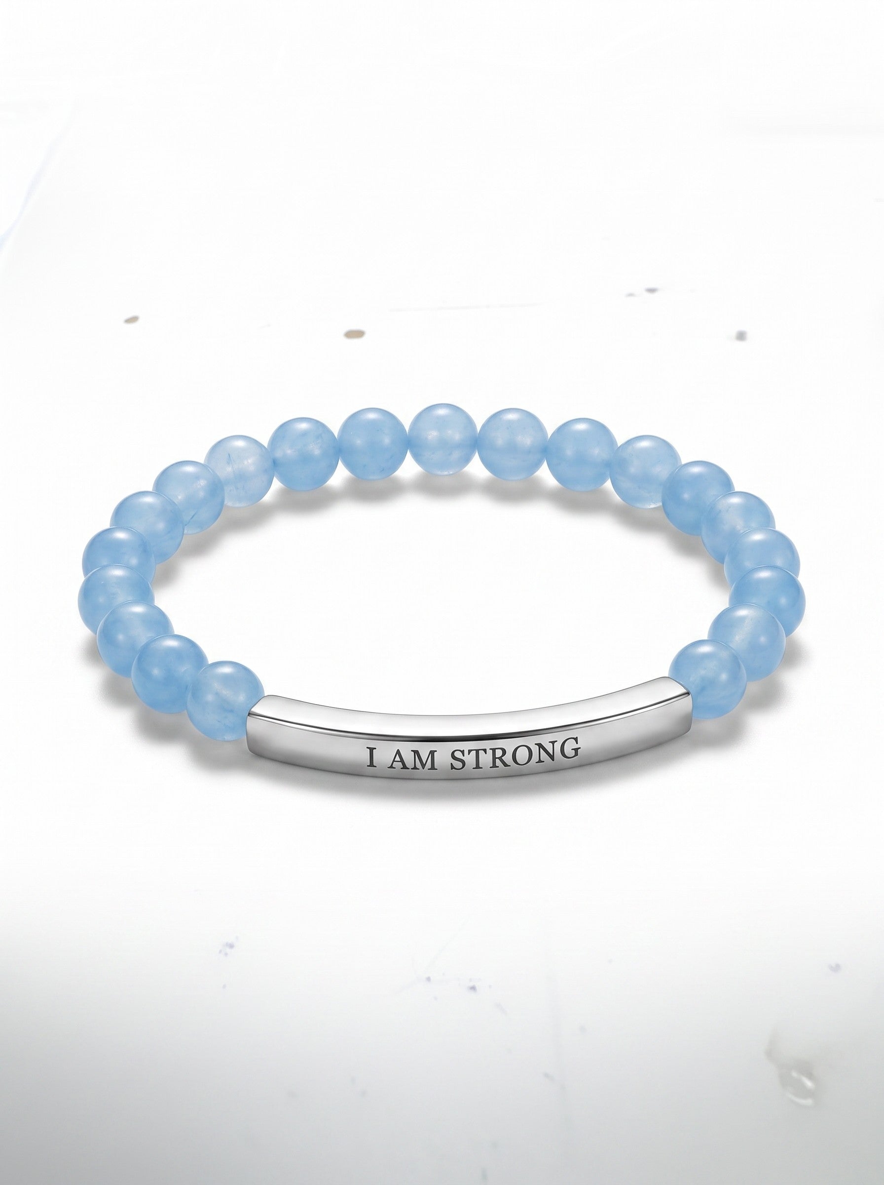 Color's Wholesale light blue beaded stretch bracelet with a silver-tone metal bar engraved with I AM STRONG