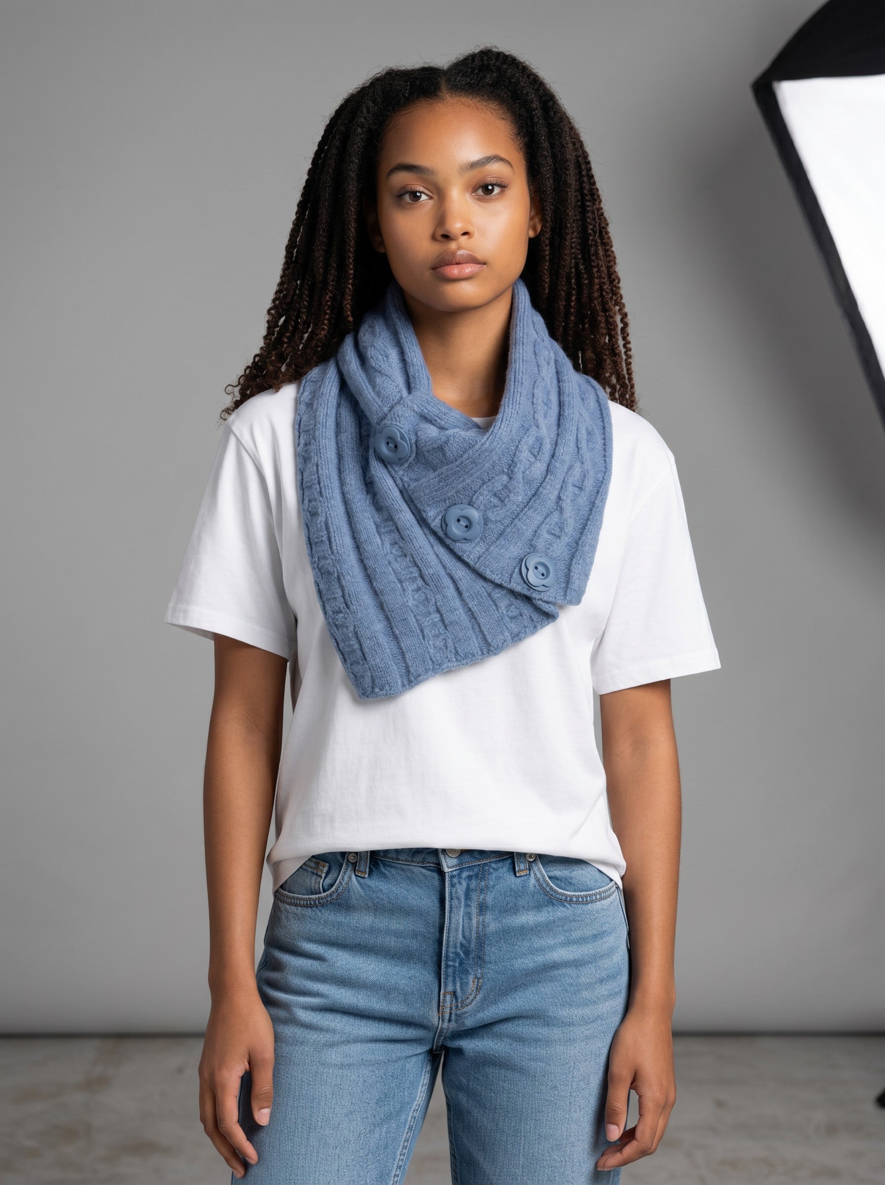 Model wearing a Color's Wholesale blue cable-knit button-detail cowl neck scarf made of chinlon, acrylic, and viscose.