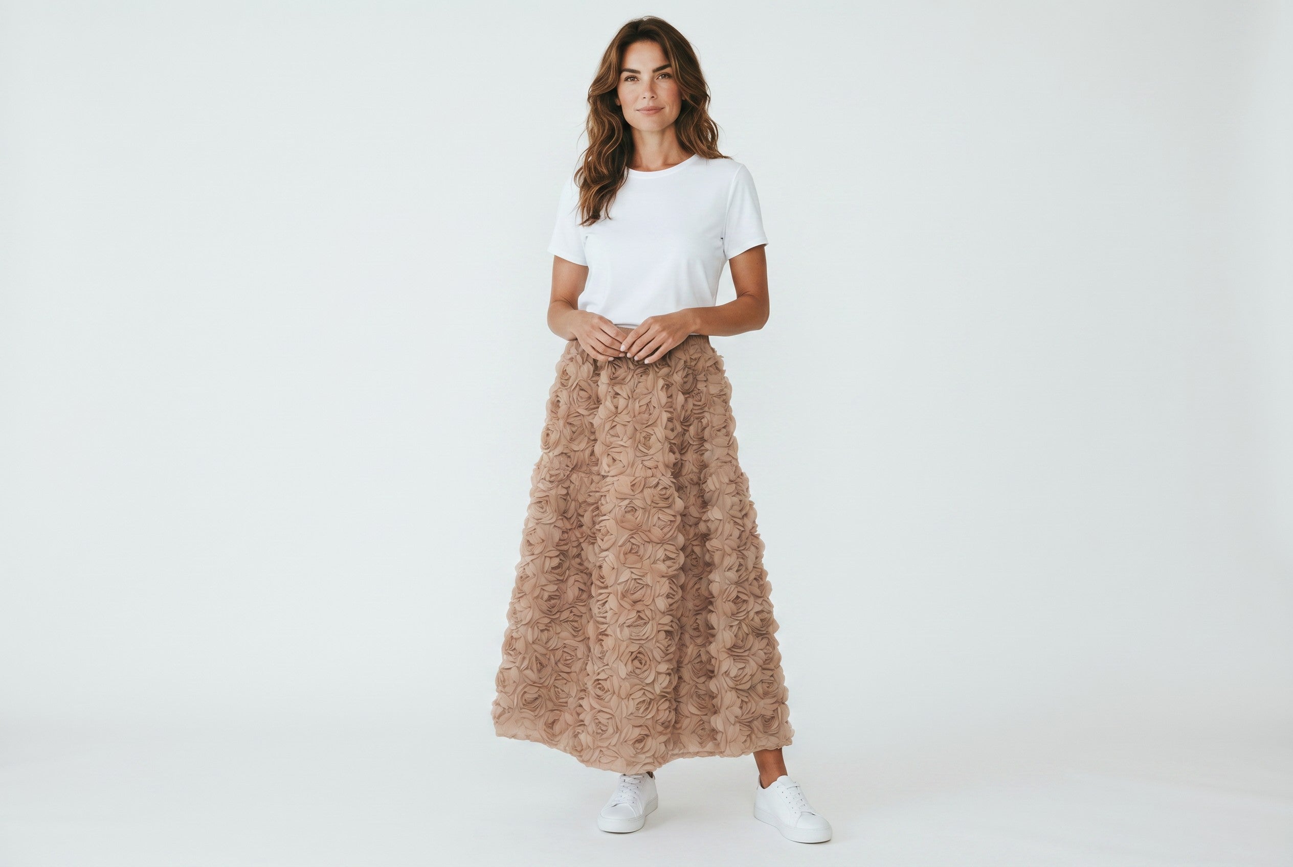 Model wearing a Color's Wholesale champagne 3D rose maxi skirt with a white t-shirt and sneakers