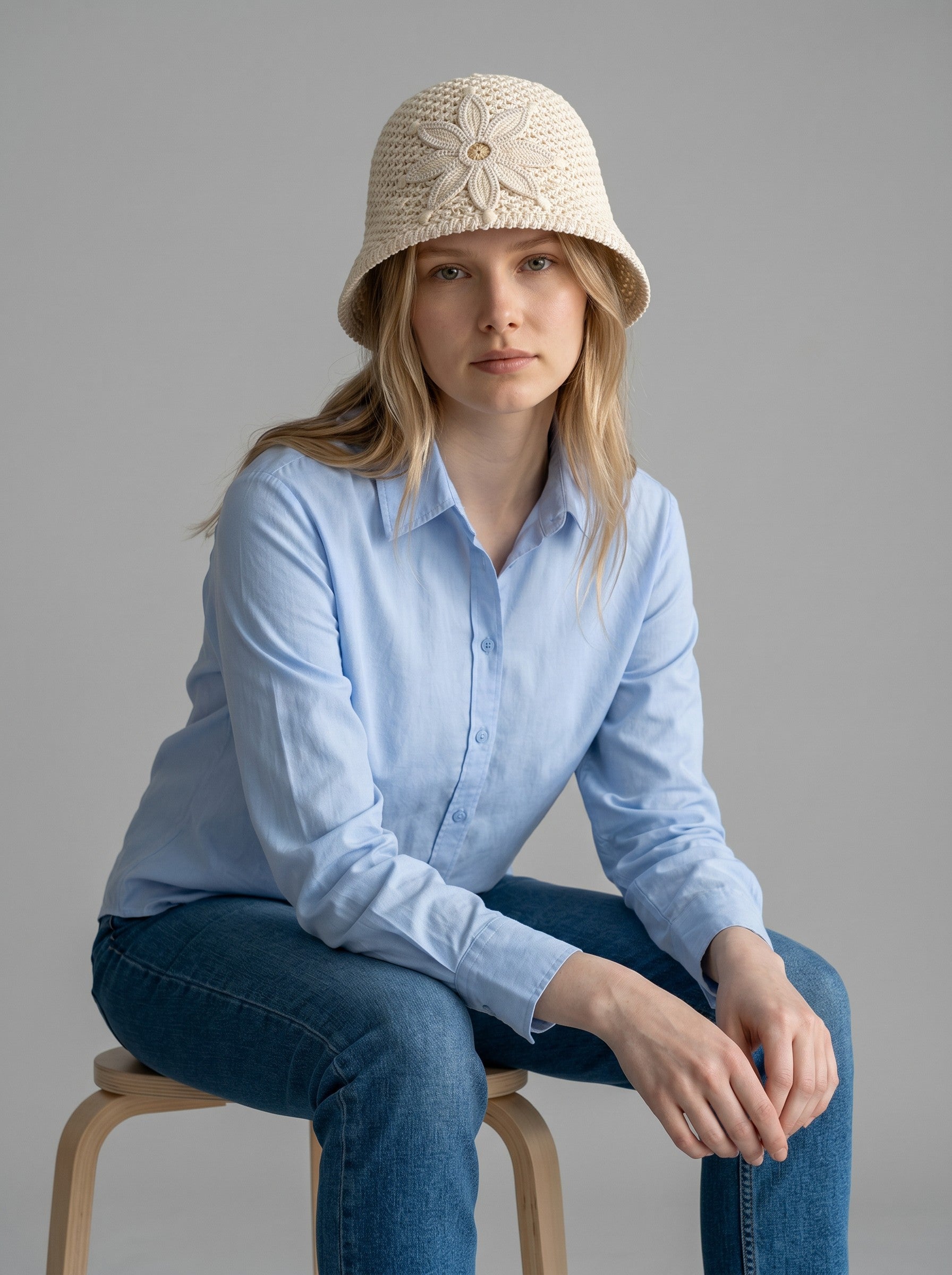 Color's Wholesale cream crocheted cotton bucket hat with flower appliqué detail.