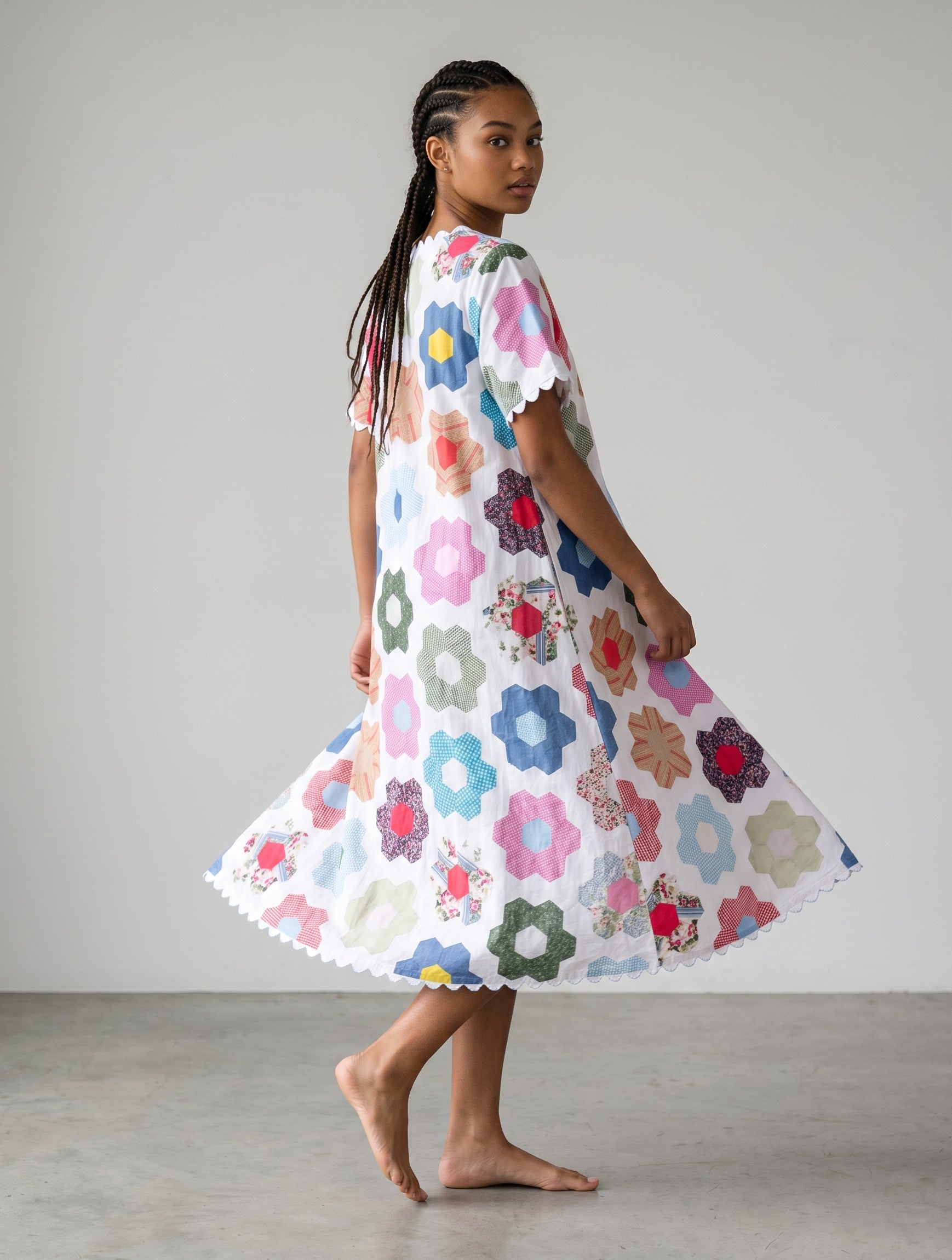 Color's Wholesale white midi dress with colorful floral patchwork print, scalloped hem and short sleeves. One size fits UK 10-16.