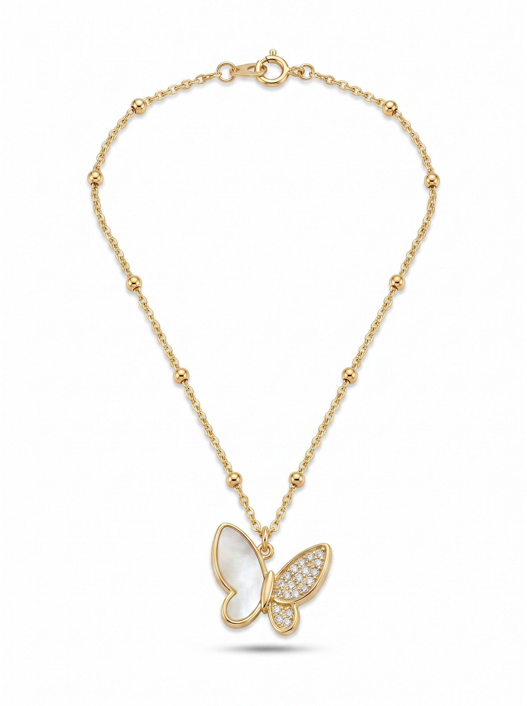 Color's Wholesale gold butterfly necklace featuring a mother of pearl wing and a pavé diamond wing on a beaded chain.