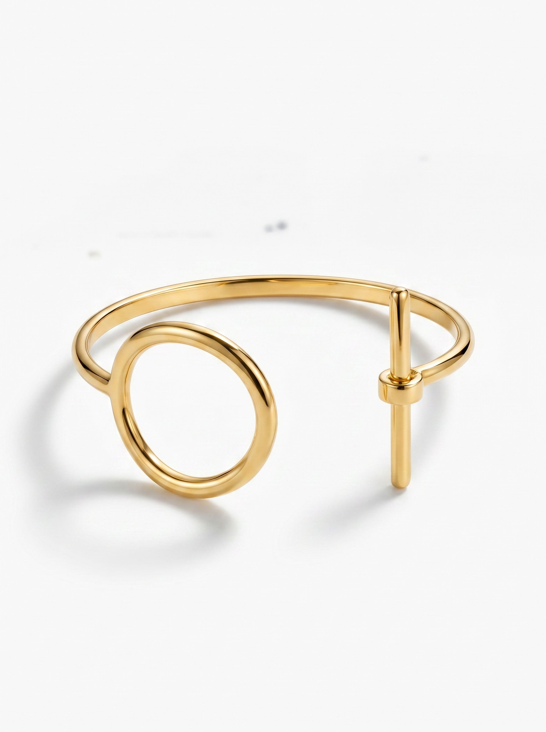 Color's Wholesale gold-tone metal open cuff bracelet featuring a minimalist circle and bar toggle design