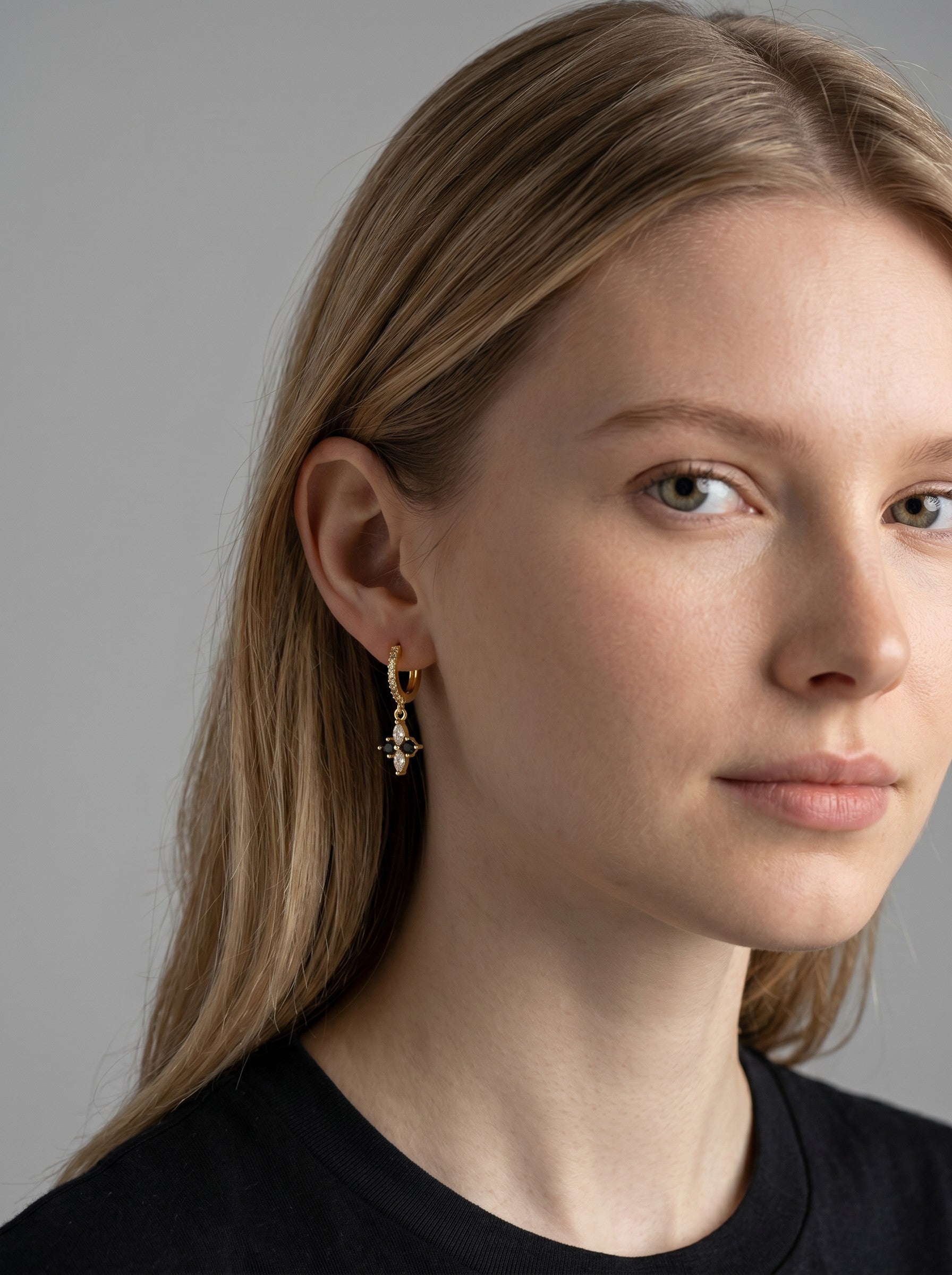 Color's Wholesale gold hoop earring with a delicate cross charm featuring small white pearls on a model