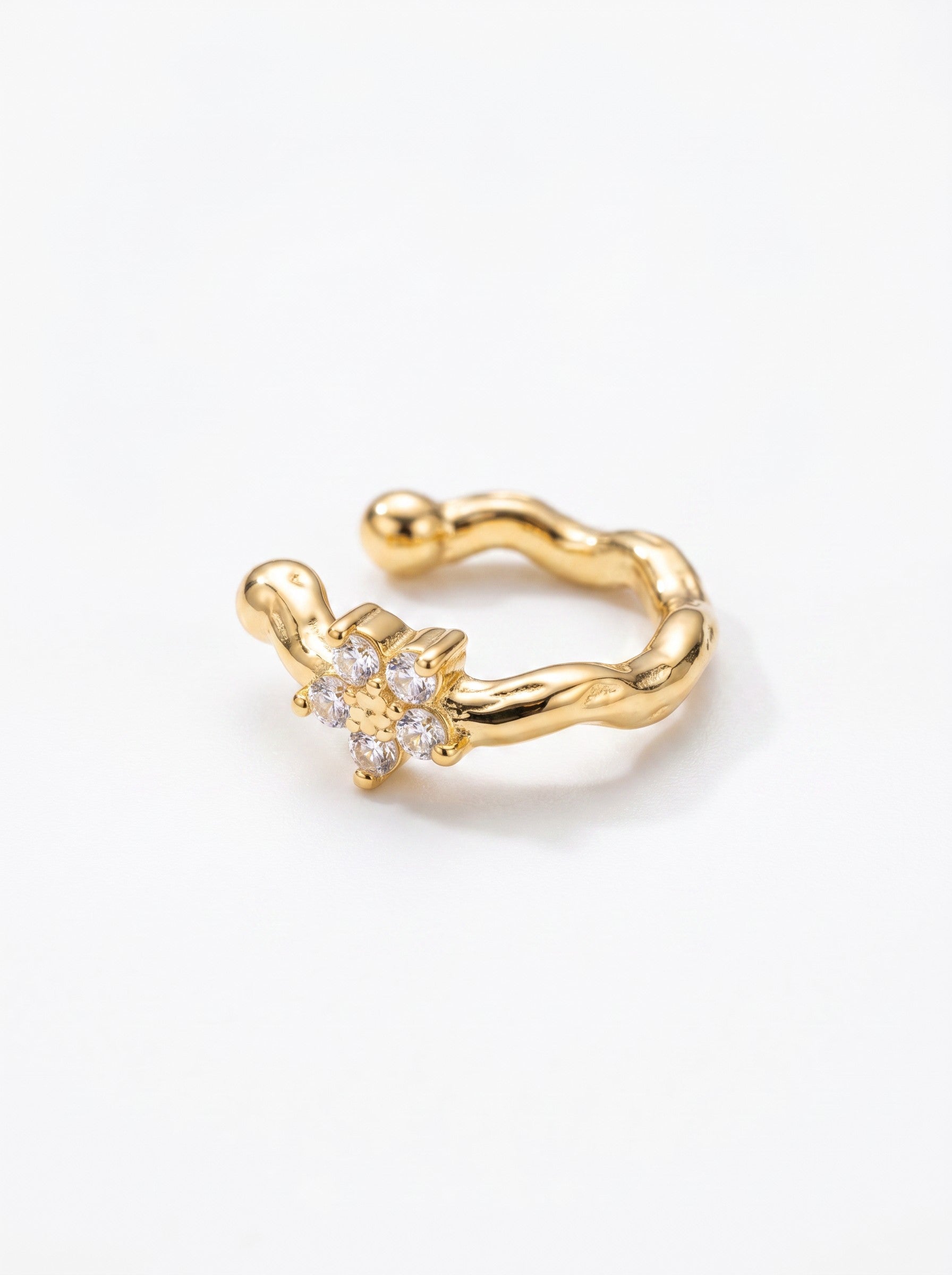 Color's Wholesale gold-toned ear cuff featuring a wavy band and a delicate flower-shaped crystal accent.