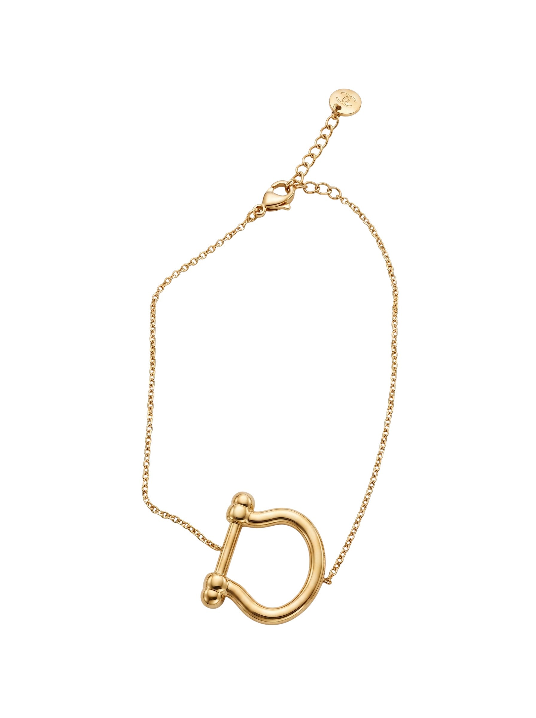 Color's Wholesale gold-tone chain bracelet featuring a large horseshoe-shaped pendant on a delicate link chain.