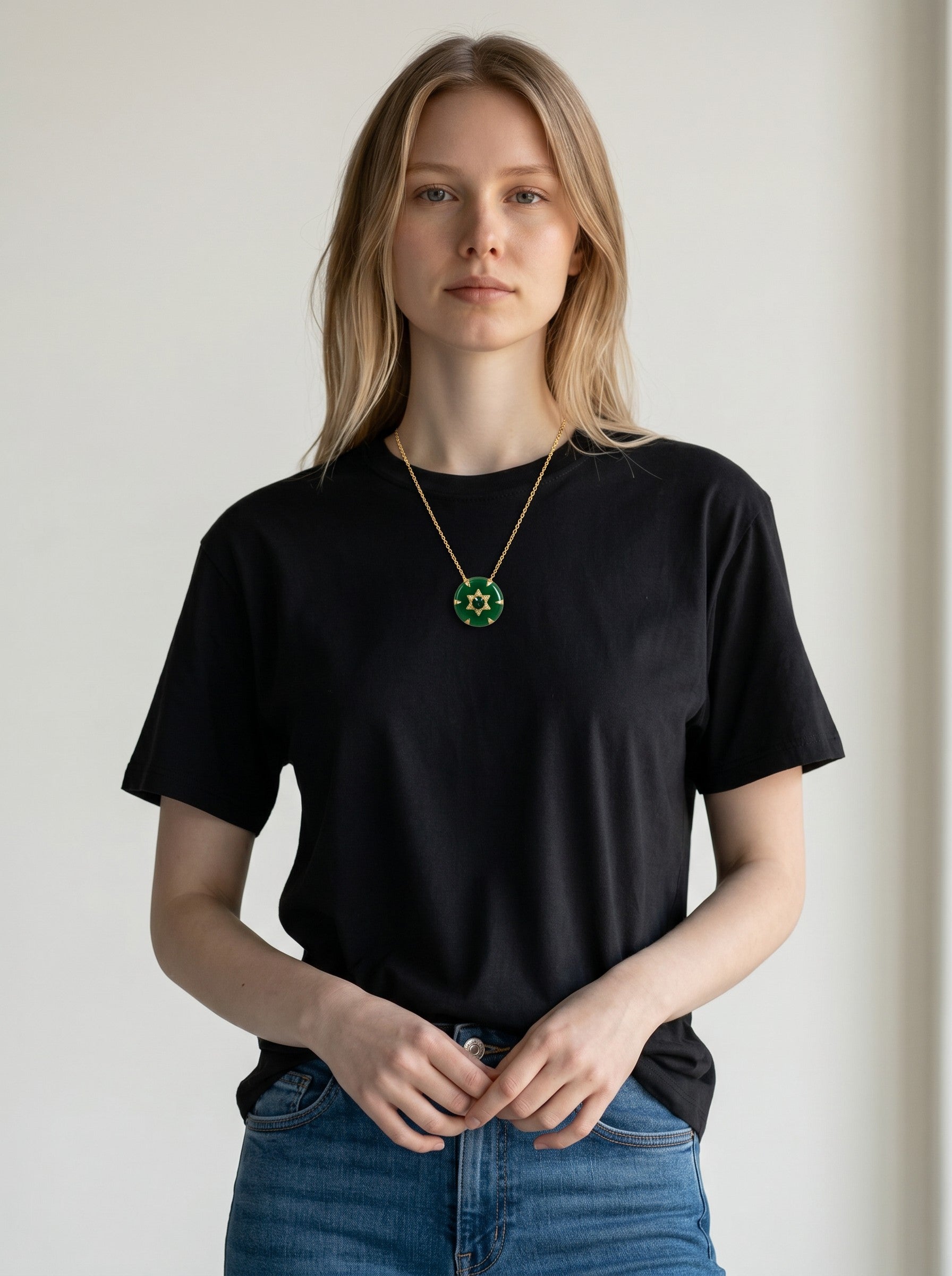Model wearing a Color's Wholesale gold chain necklace with a round green enamel pendant featuring a gold Star of David.