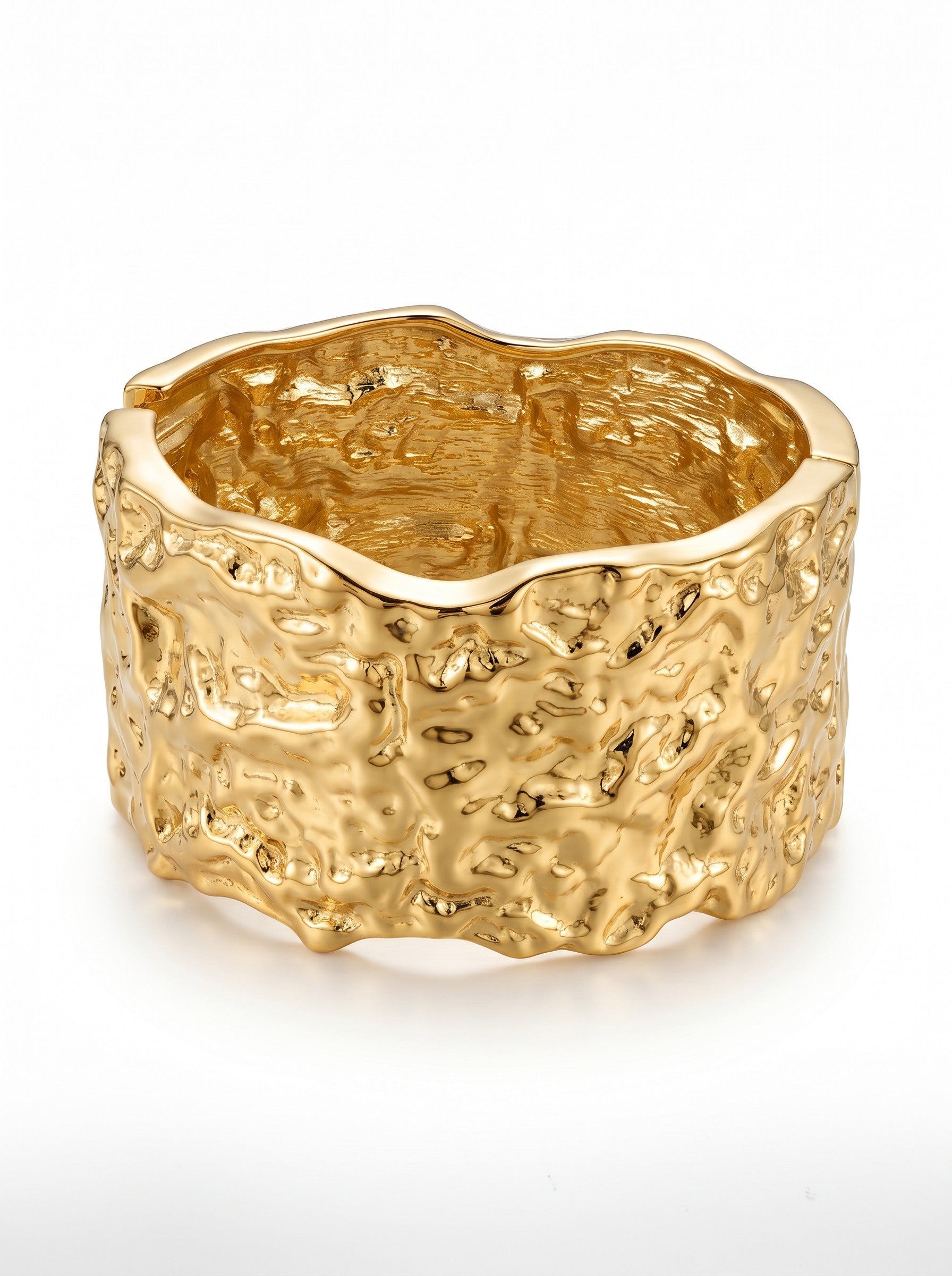 Color's Wholesale gold-tone cuff bracelet with a textured, organic molten metal finish on a white background.