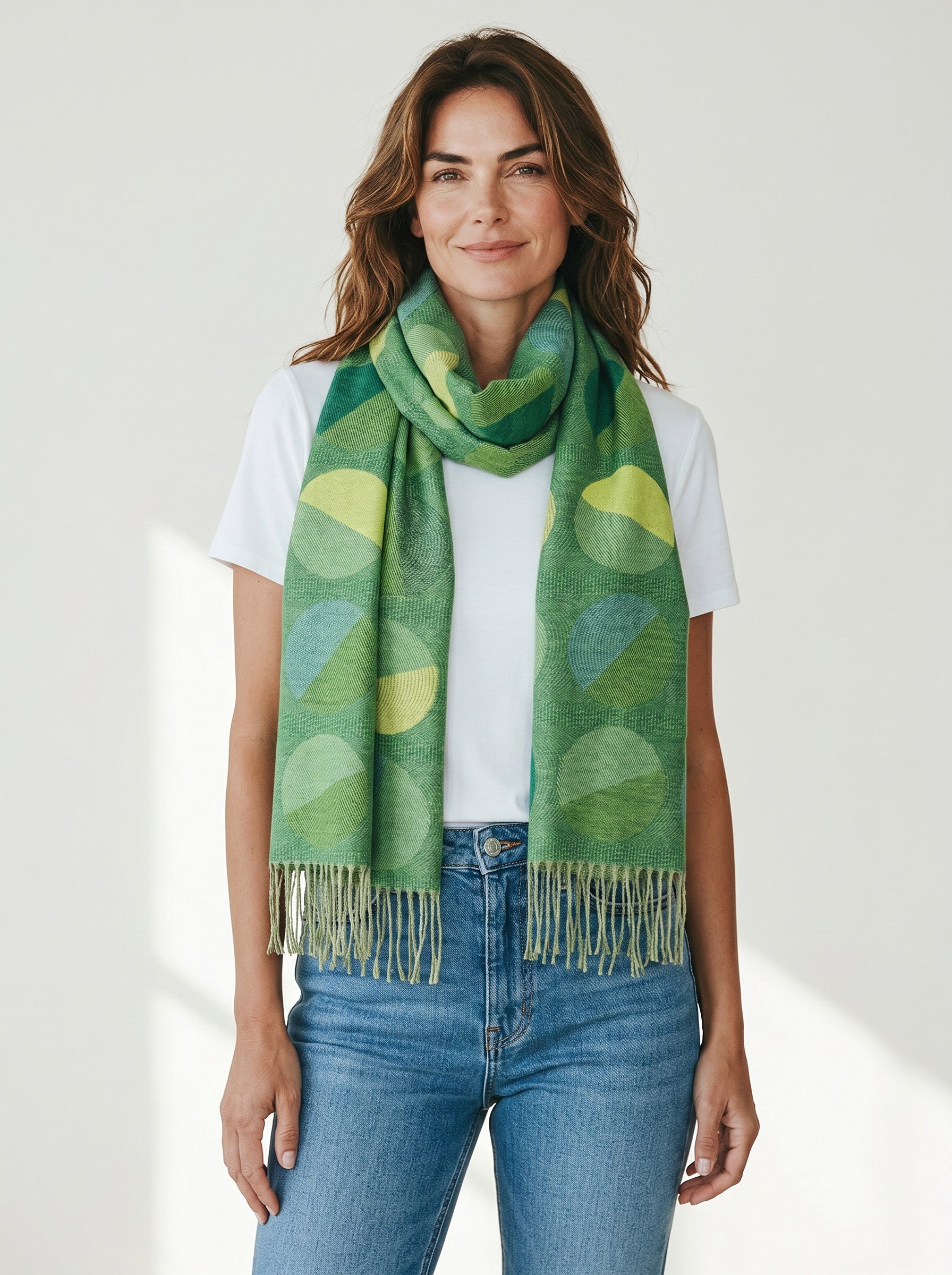 Woman wearing a Color's Wholesale green viscose scarf with a geometric circle pattern and fringe trim.