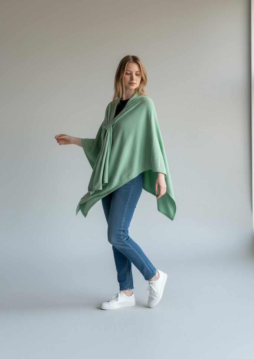 Color's Wholesale light green knit poncho with a knotted detail and draped front.