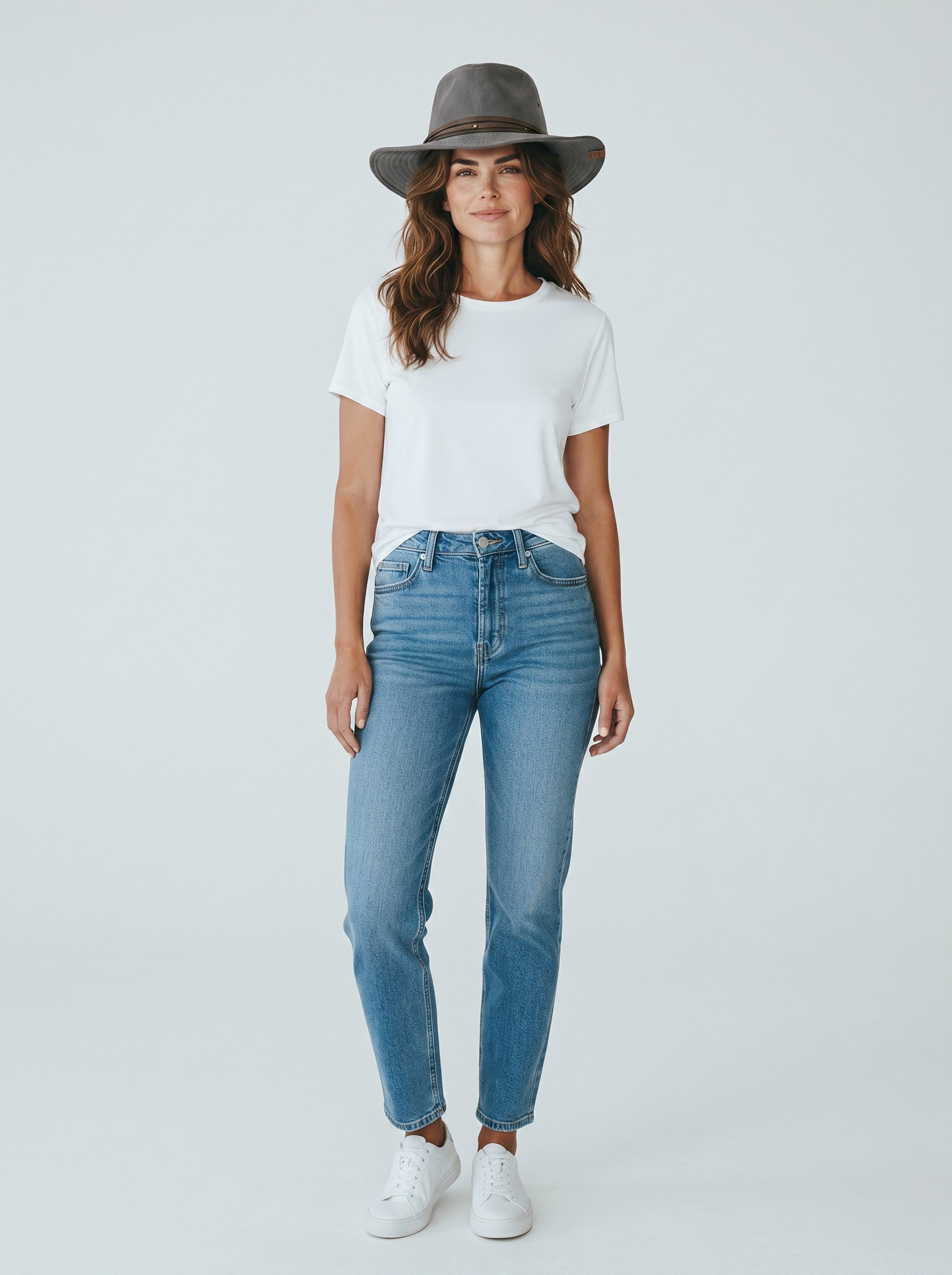 Woman wearing a Color's Wholesale grey cotton-polyester blend cowboy hat with a white t-shirt and blue jeans