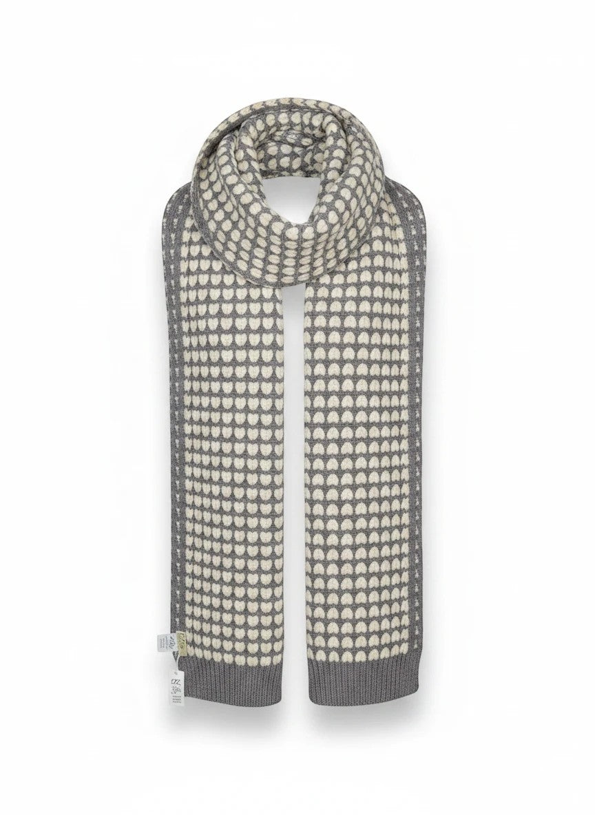 Color's Wholesale grey and cream knit scarf featuring a repeating heart pattern and ribbed trim