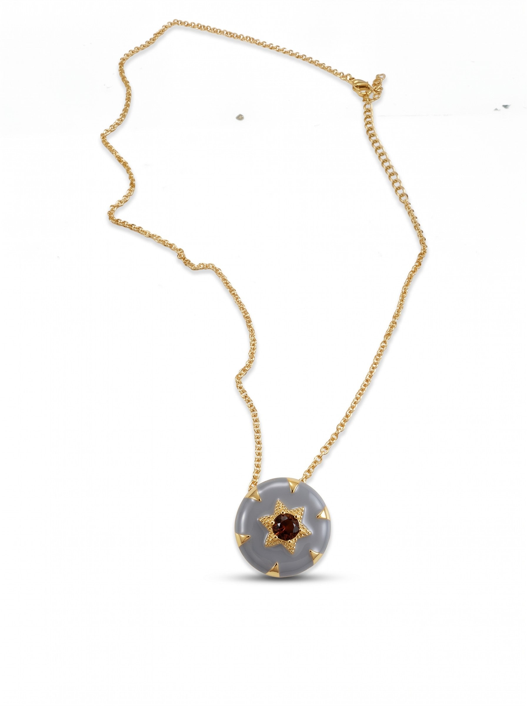 Color's Wholesale grey circular pendant necklace with a gold star accent and central dark stone on a gold chain