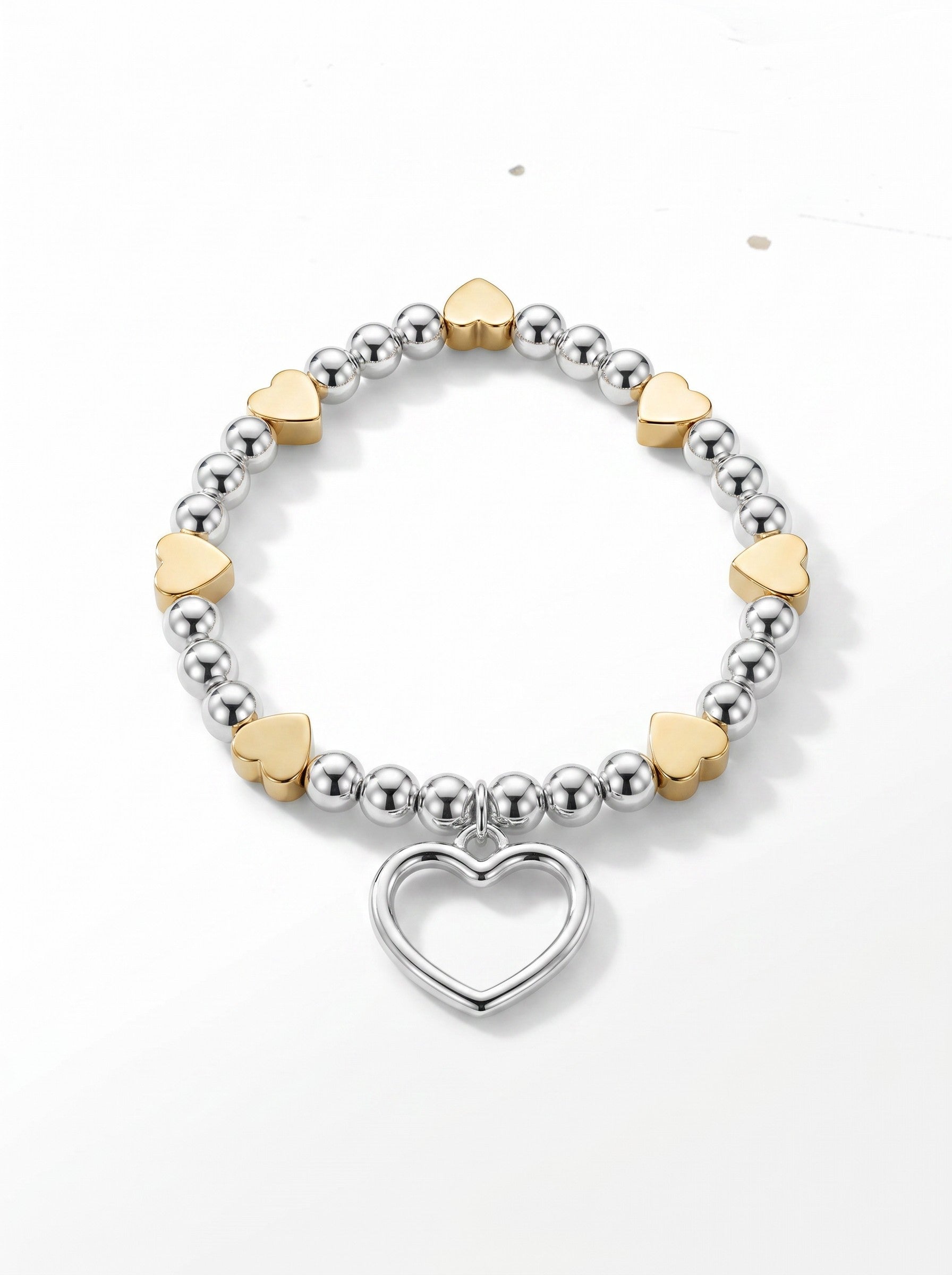 Color's Wholesale beaded charm bracelet featuring silver and gold heart beads with a central open heart pendant.