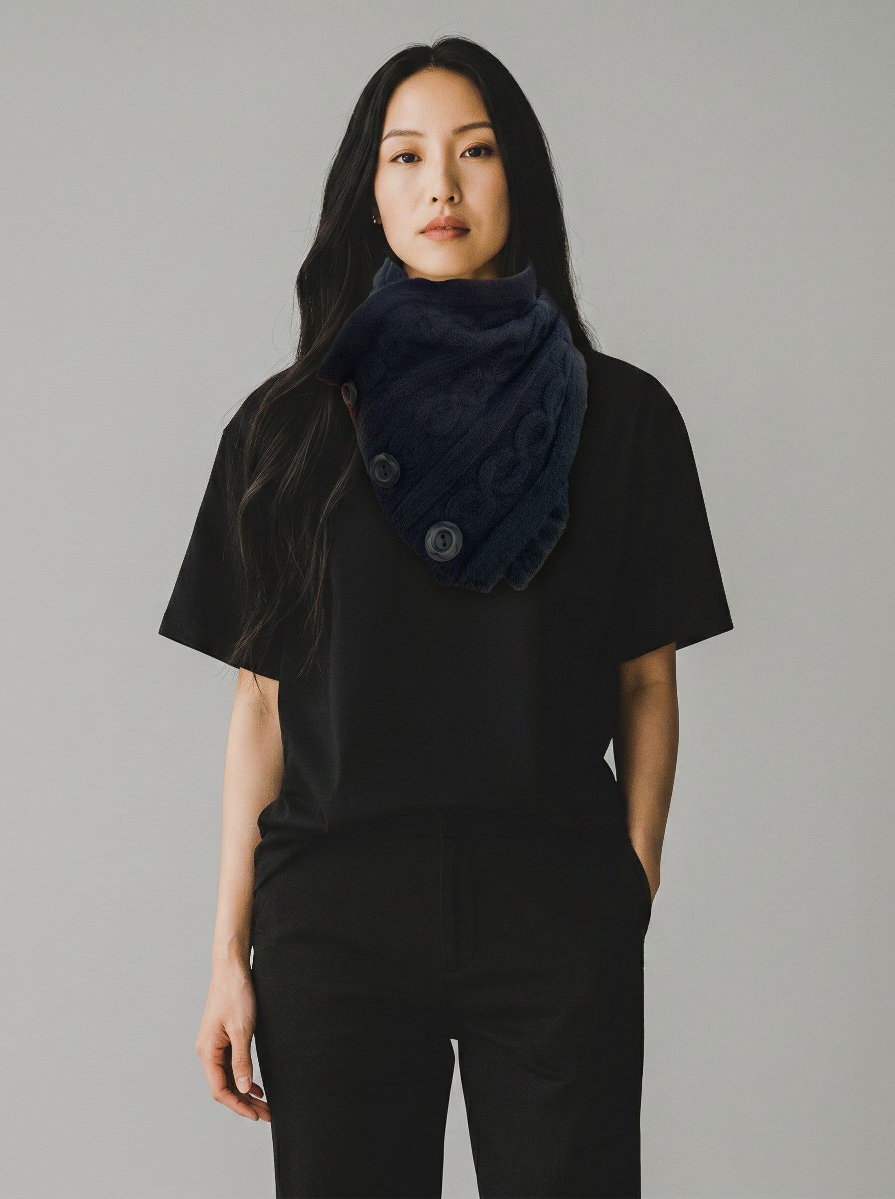 Model wearing a Color's Wholesale navy blue cable knit button-up neck warmer made of chinlon, acrylic, and viscose.