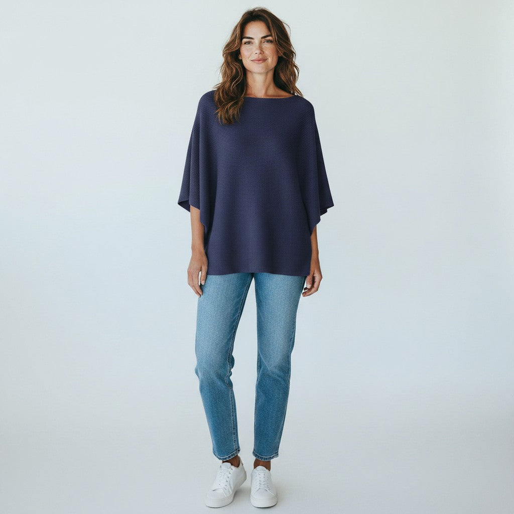 Color's Wholesale navy blue off the shoulder sweater with wide sleeves and ribbed texture.