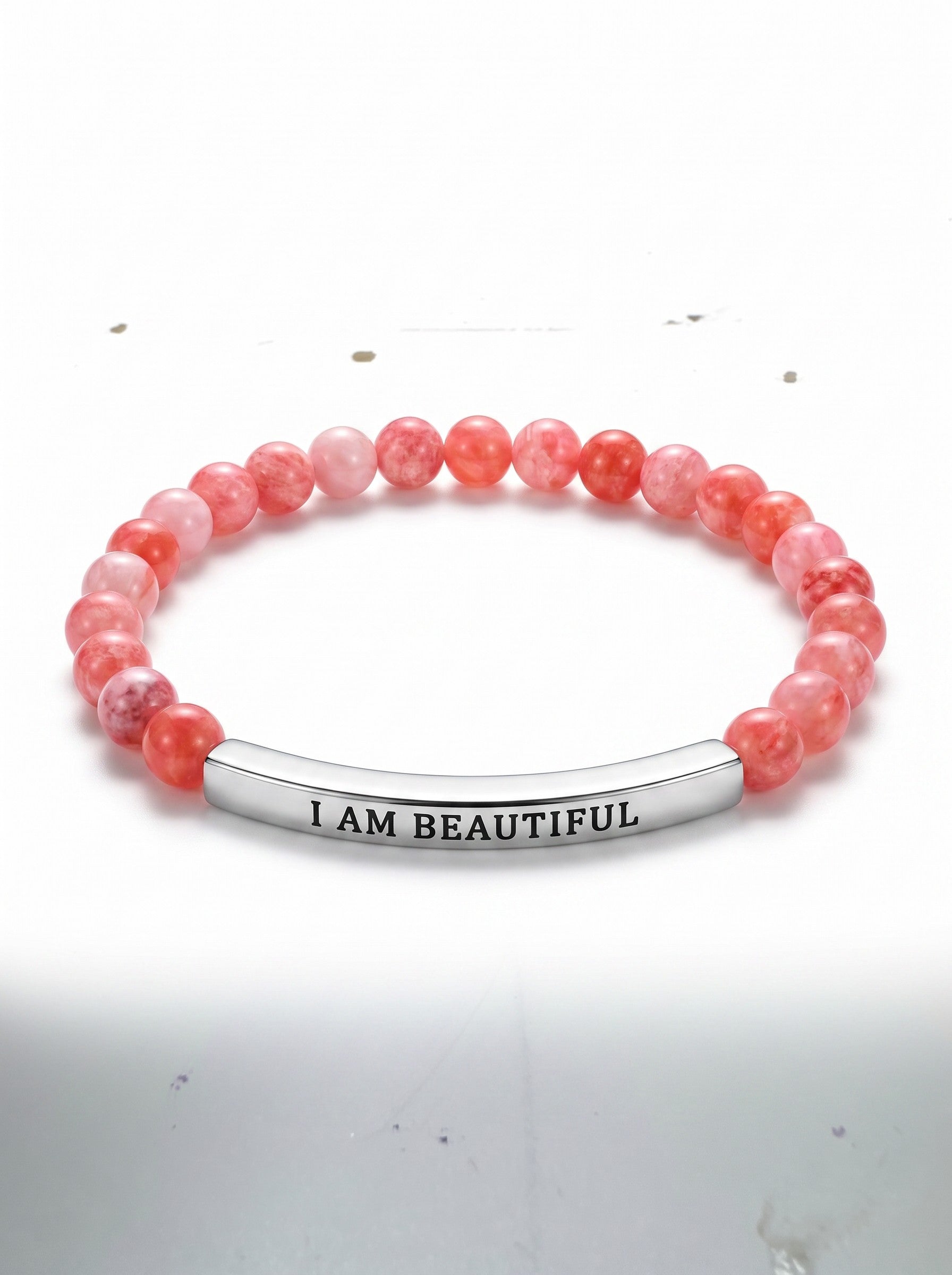 Color's Wholesale pink beaded stretch bracelet with a silver bar charm engraved with the words I AM BEAUTIFUL