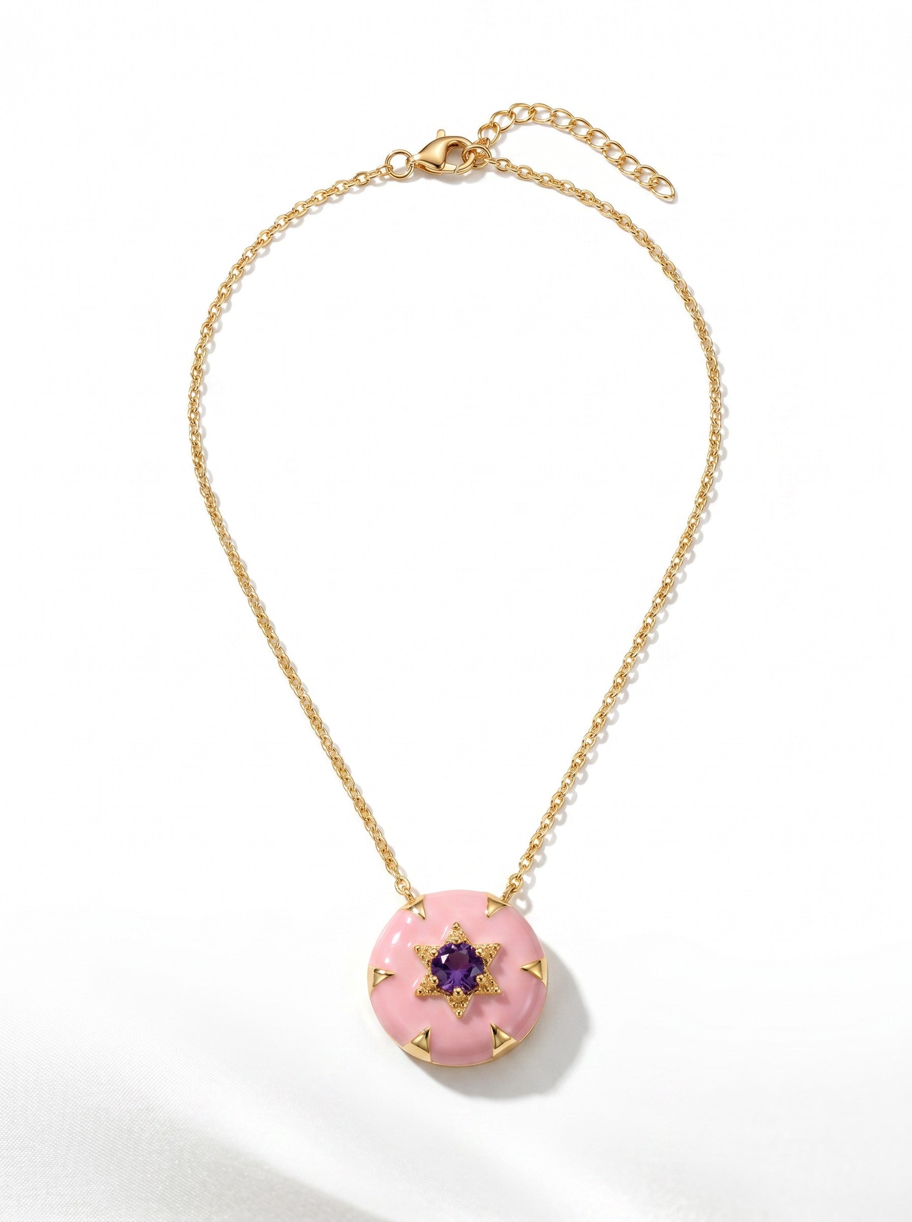 Color's Wholesale gold chain necklace featuring a round pink enamel pendant with a central purple star-shaped gemstone.