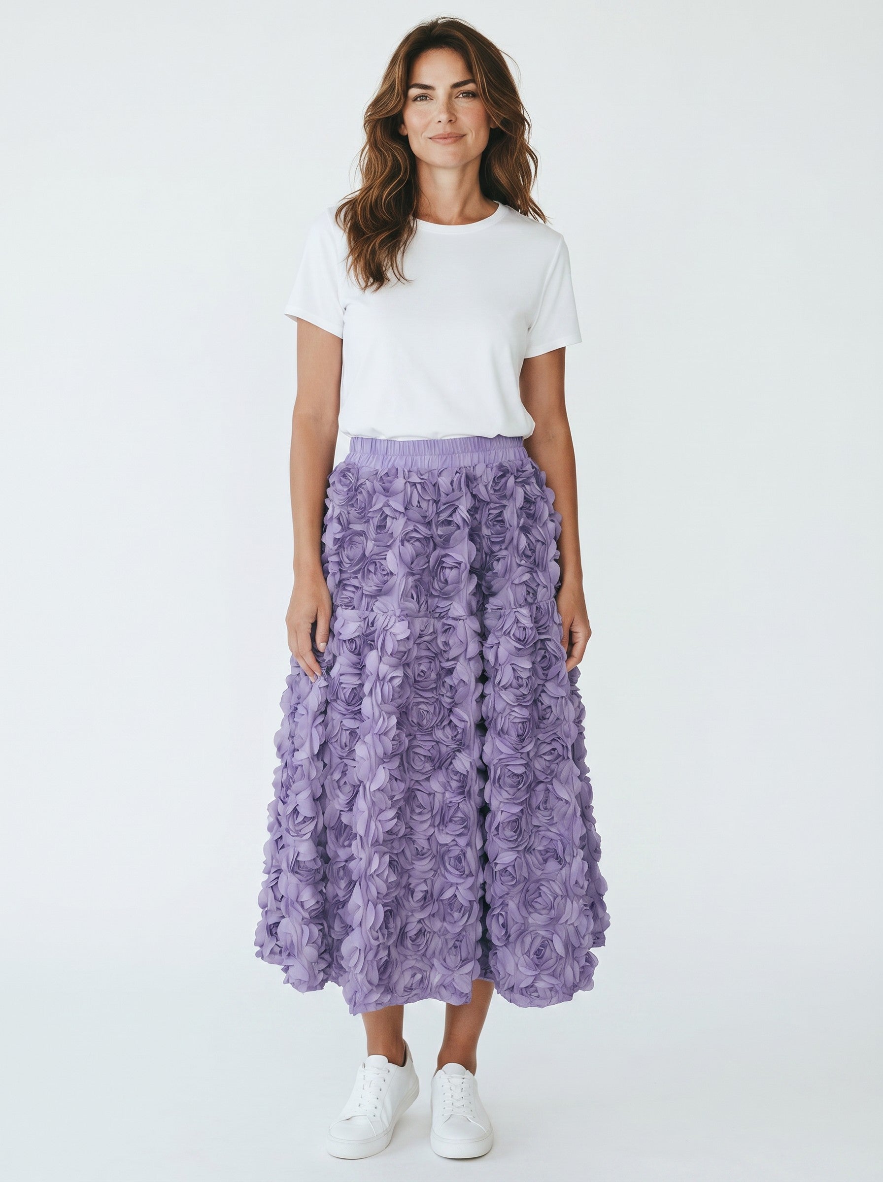 Model wearing a Color's Wholesale purple midi skirt with 3D rose petal texture, white t-shirt, and white sneakers.