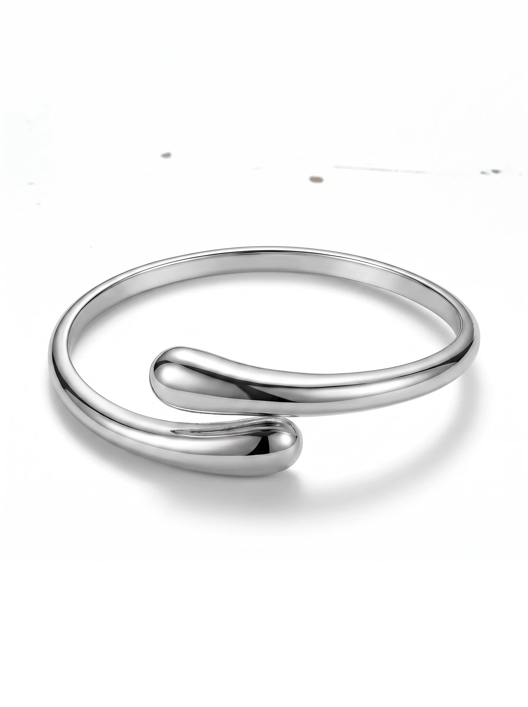 Color's Wholesale silver-tone modern bypass cuff bracelet with a polished metallic finish on a white background.