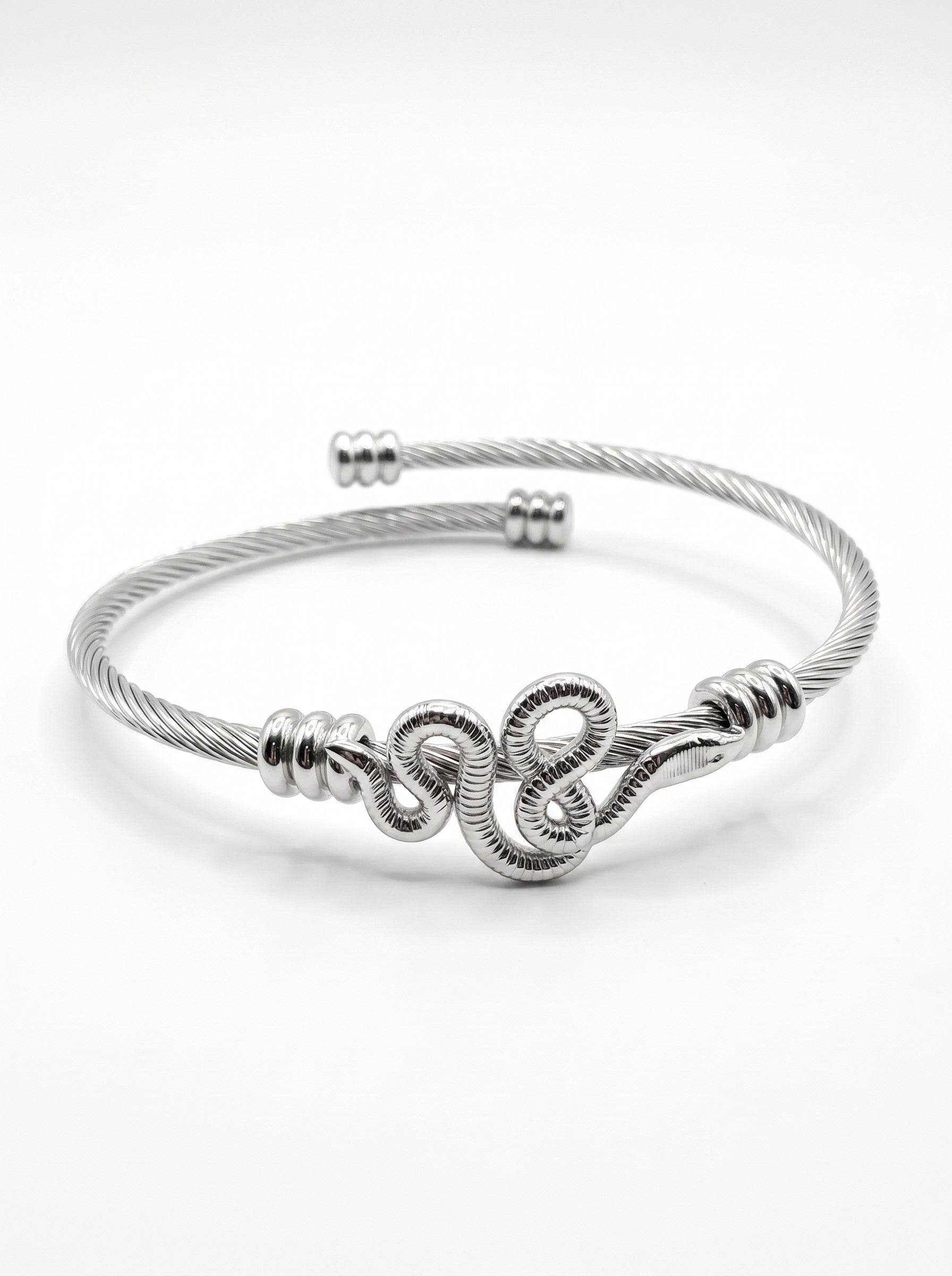 Color's Wholesale silver-tone twisted cable bangle bracelet featuring a central coiled snake design.
