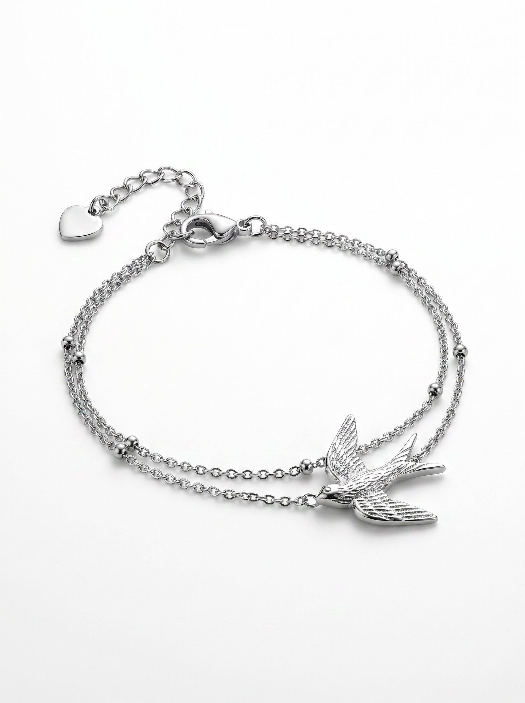 Color's Wholesale silver double-chain bracelet featuring a swallow bird charm and small bead accents.