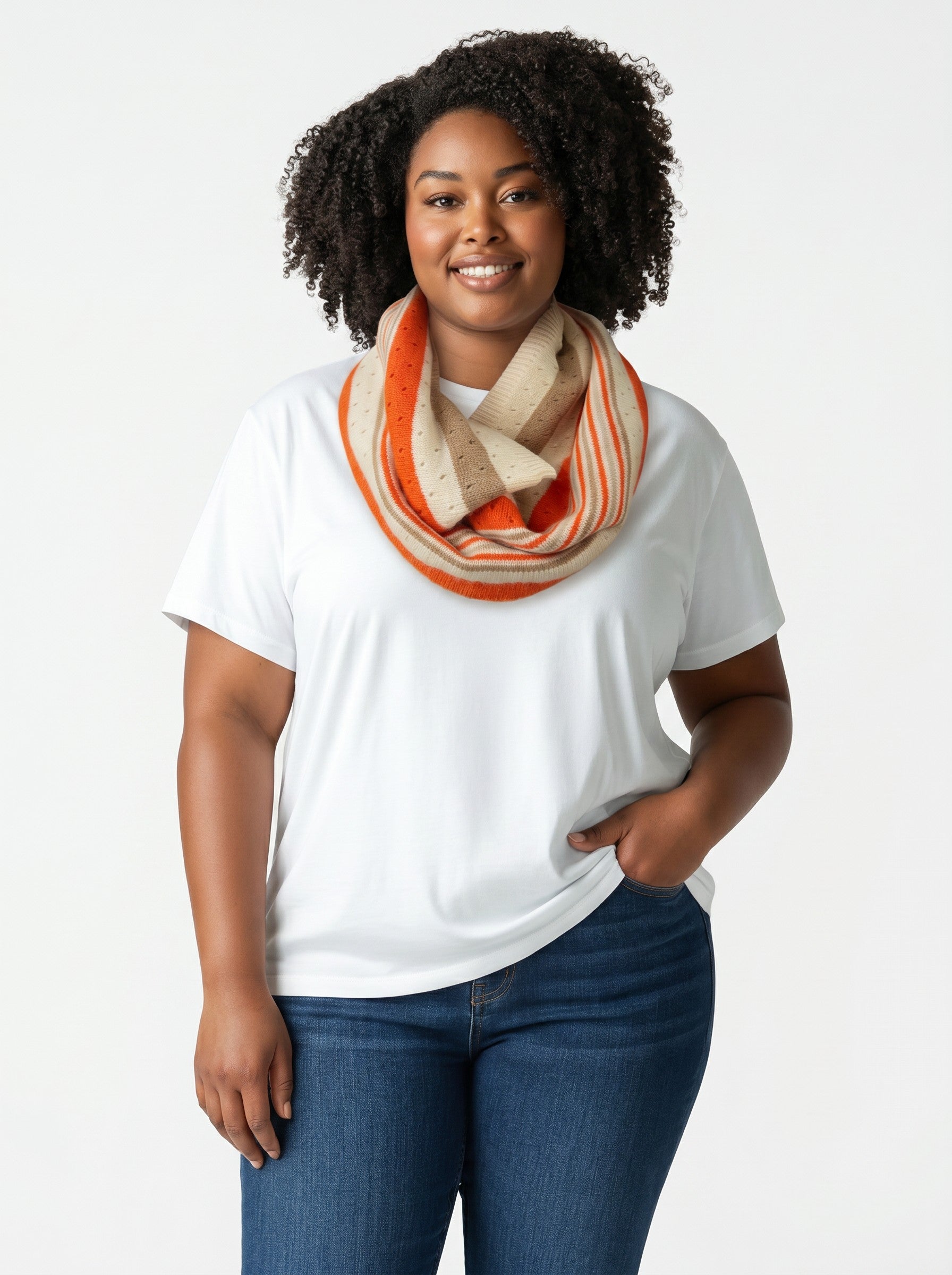 Model wearing a Color's Wholesale infinity scarf with orange and beige stripes and a dotted knit pattern